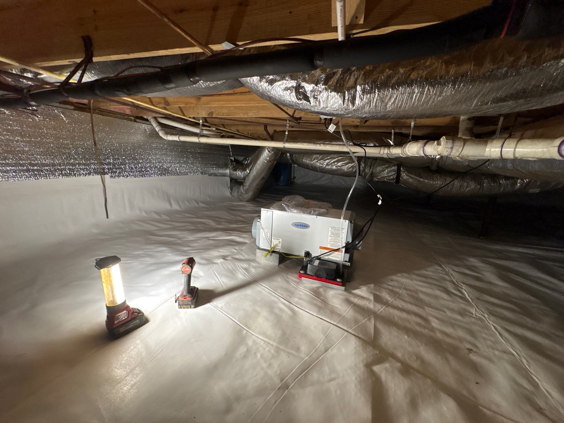 Crawl space dehumidifier installed on the vapor barrier in an encapsulated Roanoke, VA crawl space